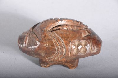 a small figurine of a fish on a table