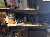 a black shelf with speakers and other electronics on it