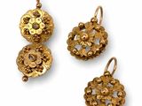 three pieces of gold jewelry on a white background
