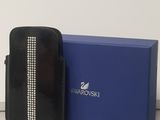 the black purse is next to a blue box with a name tag