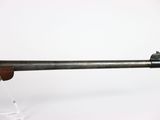 a rifle with a wooden barrel on a white background