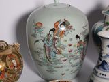 a group of asian vases and bowls on a table