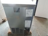 a small refrigerator sitting on a pallet in a room
