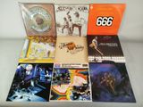 various albums and cds are arranged on a white surface
