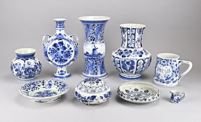many blue and white vases and bowls on the table