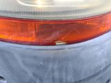 the rear end of a car that has been covered in a sheet of plastic