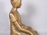 an image of a statue of a woman sitting on top of a wooden block