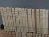 many books stacked on top of each other on a table
