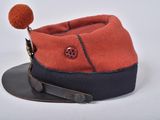 orange and black hat with a button on top of it