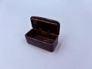 a small brown box on a table with a white background