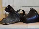 three pairs of shoes that are sitting on a ledge