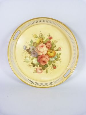 a plate with flowers on it on a white surface