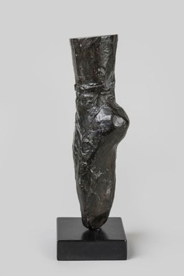 an image of a sculpture of a woman ' s foot on a black base