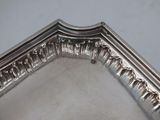a close up of a silver tray on a white surface