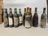 bottles of wine are lined up on a table in front of a white backdrop