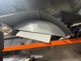 a lot of metal items on a shelf in a warehouse