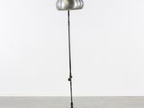 a metal floor lamp with a metal base and a metal shade