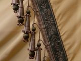 a close up of a curtain with bells hanging from it
