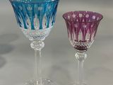two wine glasses sitting next to each other on a table