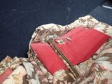 a bag that is sitting on the floor next to a pillow