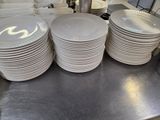 a lot of plates stacked on the counter in the kitchen