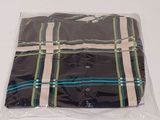 a plaid shirt wrapped in plastic on a white table