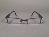 a pair of glasses sitting on a table next to each other