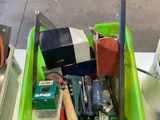 a green container filled with assorted items on a table