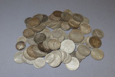 a pile of coins sitting on a table next to a pair of scissors
