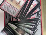 a tin of cards in a tin case with a few cards in it