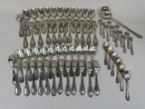 many spoons and spoons laid out on the table
