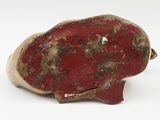 a red object on a white surface with a white background