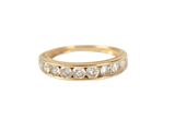 a close up of a gold ring with diamonds on a white background