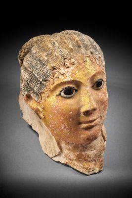 a close up of a clay head of a woman