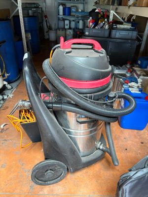 a vacuum that is sitting on the floor in the garage