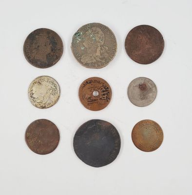 several different types of coins are arranged on a white surface