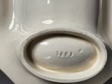 an image of a close up of a vase with a spoon in it