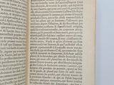 an open book on a white surface with a blue background