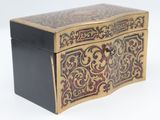 a black and gold box sitting on a white surface