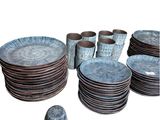 a lot of plates and cups sitting on a table