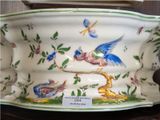 a large white bowl with birds and flowers on it