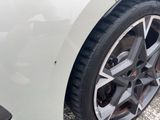 a close up of a tire on a white car