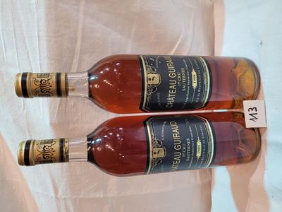 two bottles of wine that are sitting on a table