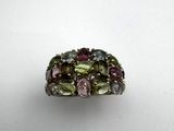 a close up of a ring with multi colored stones on it