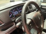 dashboard view of a car with a steering wheel and dashboard lights