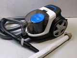 a vacuum that is sitting on the floor next to a stick