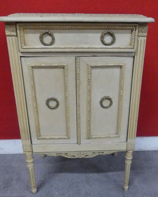 an image of a white cabinet with two doors and a drawer on top