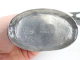 a person holding a spoon with a handle in their hand