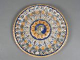 a blue and yellow plate with a face on it