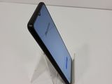 a close up of a cell phone on a stand on a table